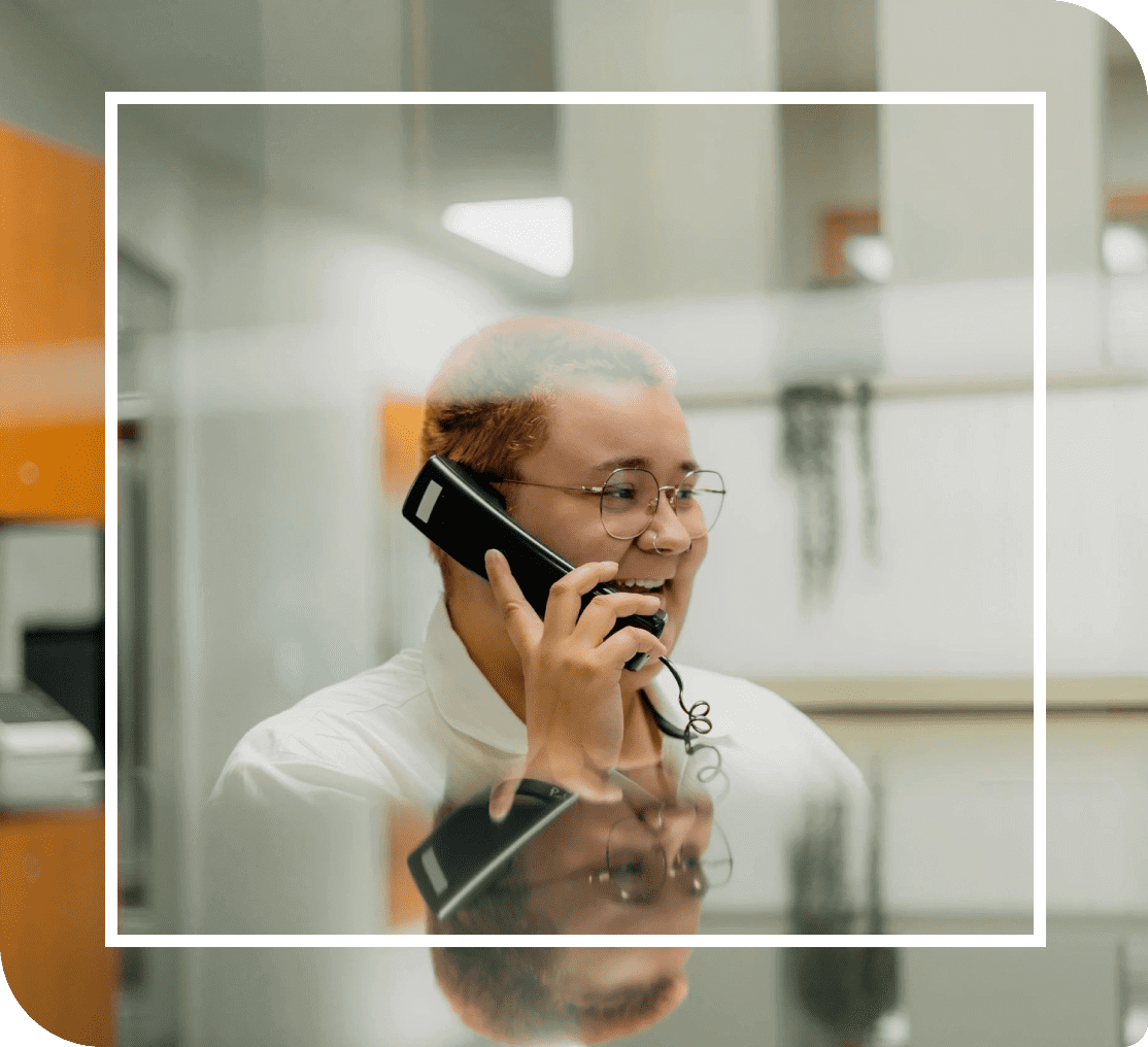 Person talking on phone in office setting.