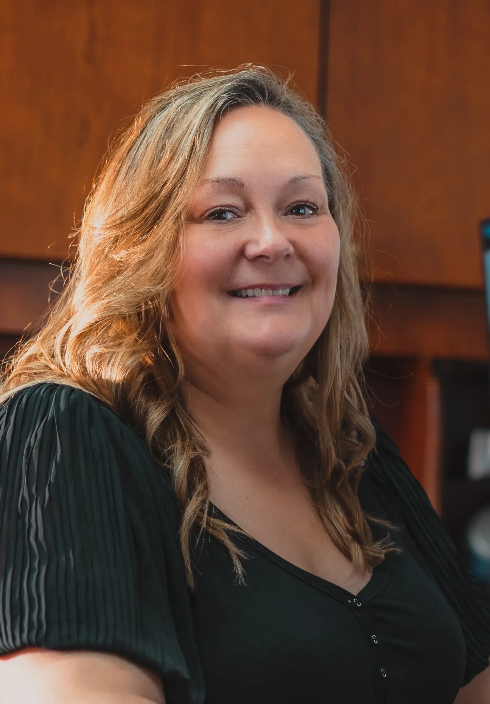Smiling woman sitting in an office.
